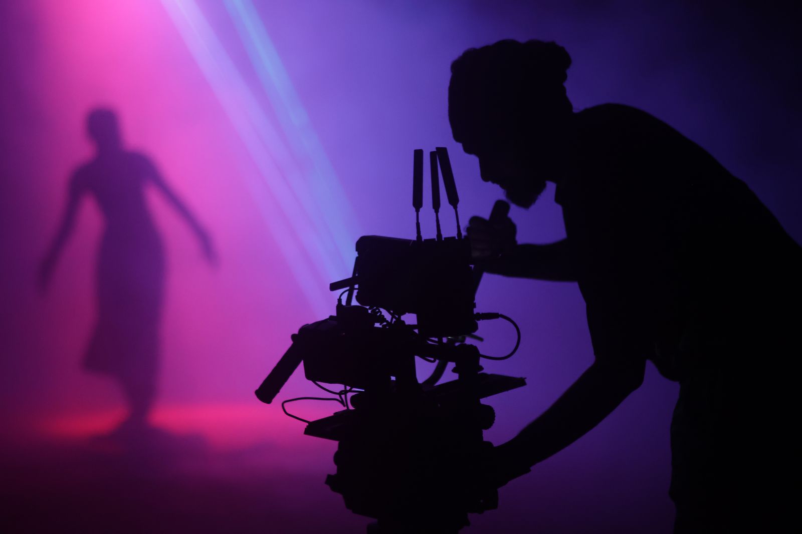 Cinematographer silhouette — purple & pink cinematic lighting